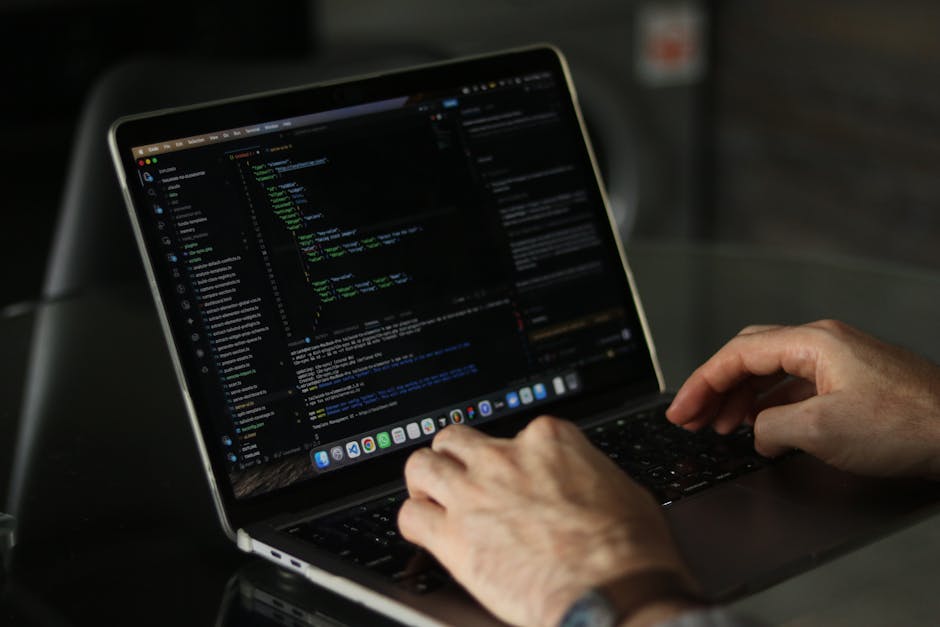 Close-up view of a computer monitor displaying lines of HTML code in a text editor. The code includes elements such as the DOCTYPE declaration, HTML, head, meta tags, title, and link tags for styleshe